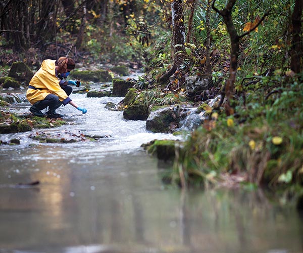 person cleaning up river